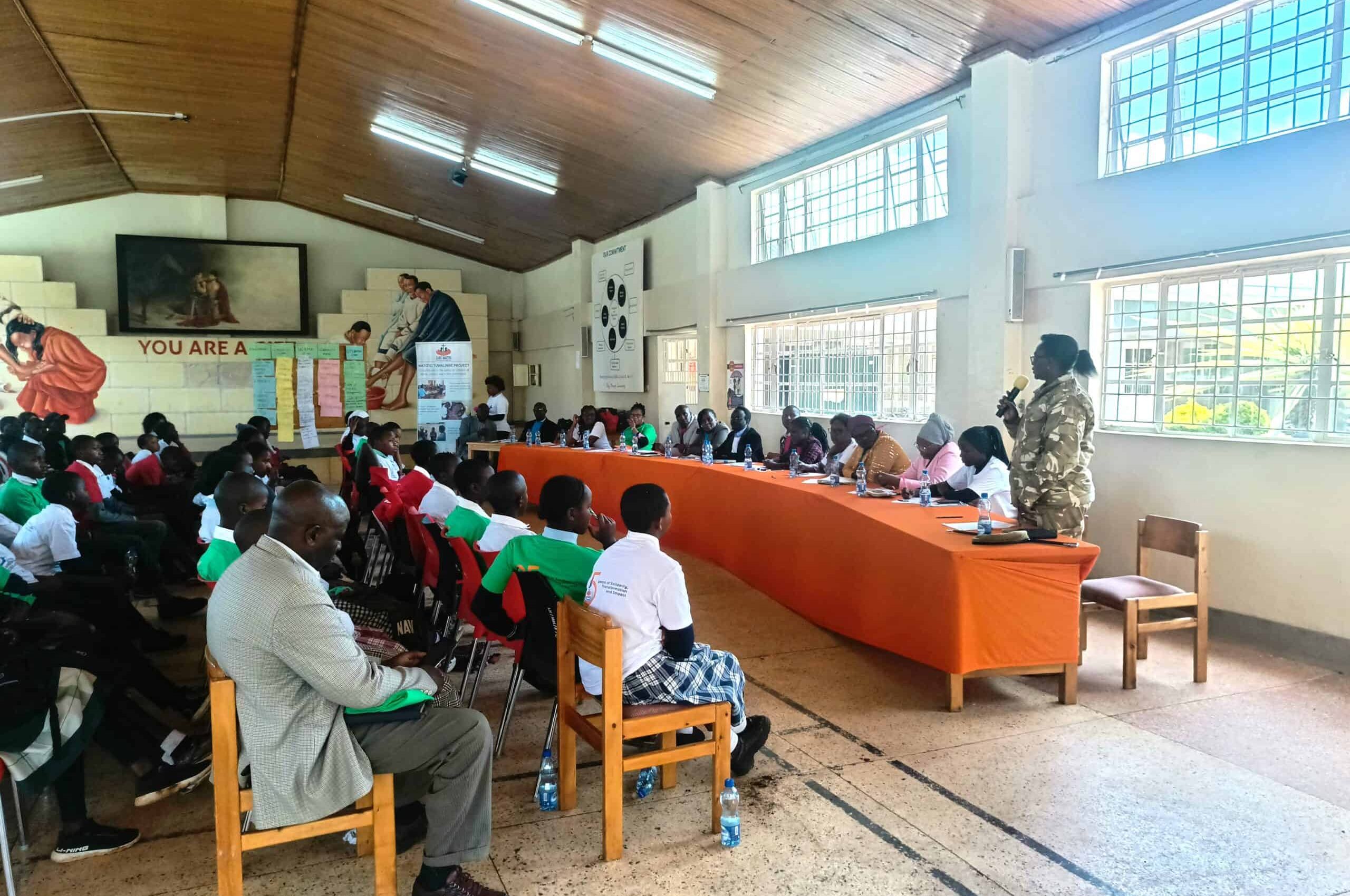 An officer in-charge of wildlife in the sub-county create awareness to children