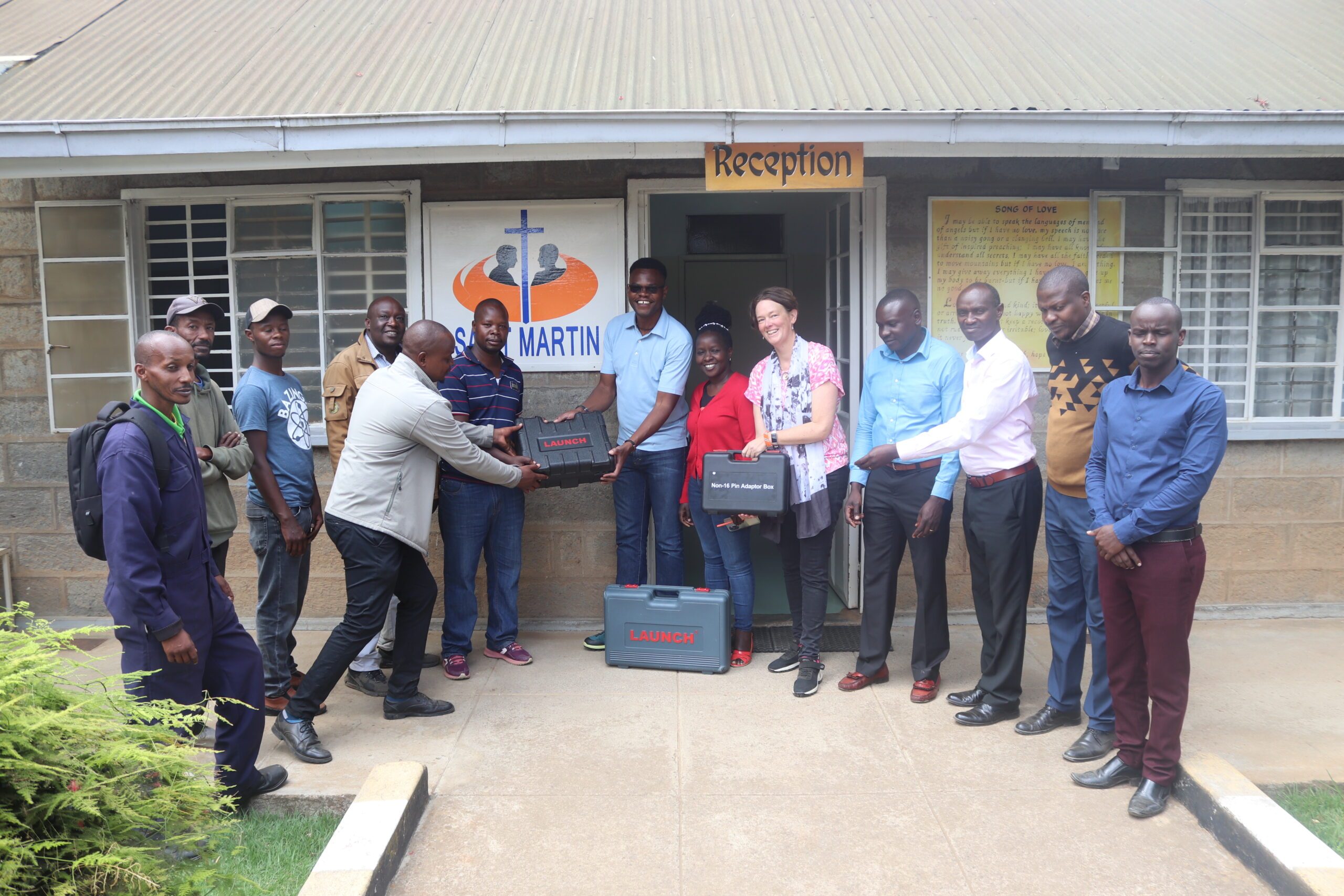 St Martin director handing over of motor vehichle diagnosis machine to Nyahururu VTC manager and instructors-photo by Nicholas